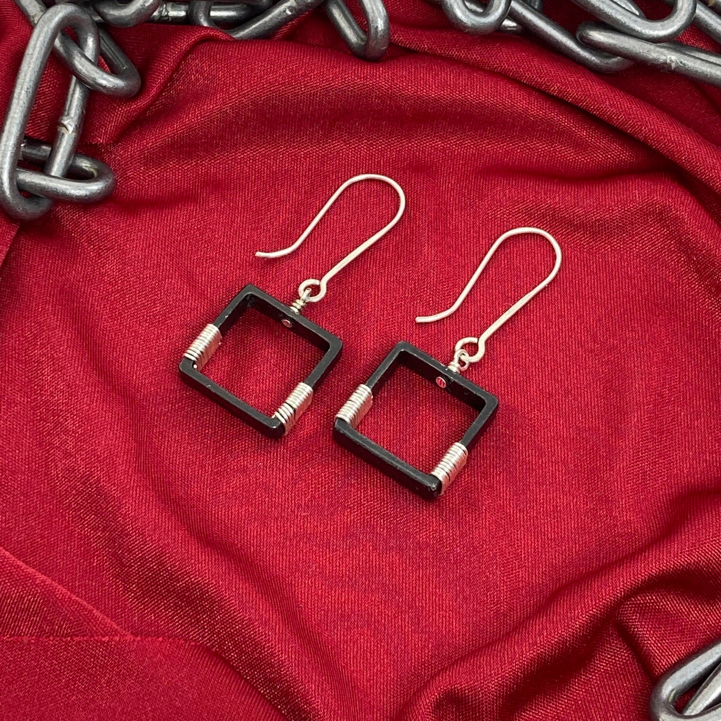 Blackened steel earrings wrapped with silver