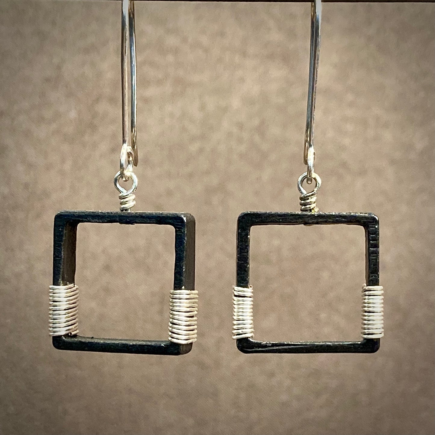 Blackened steel earrings wrapped with silver