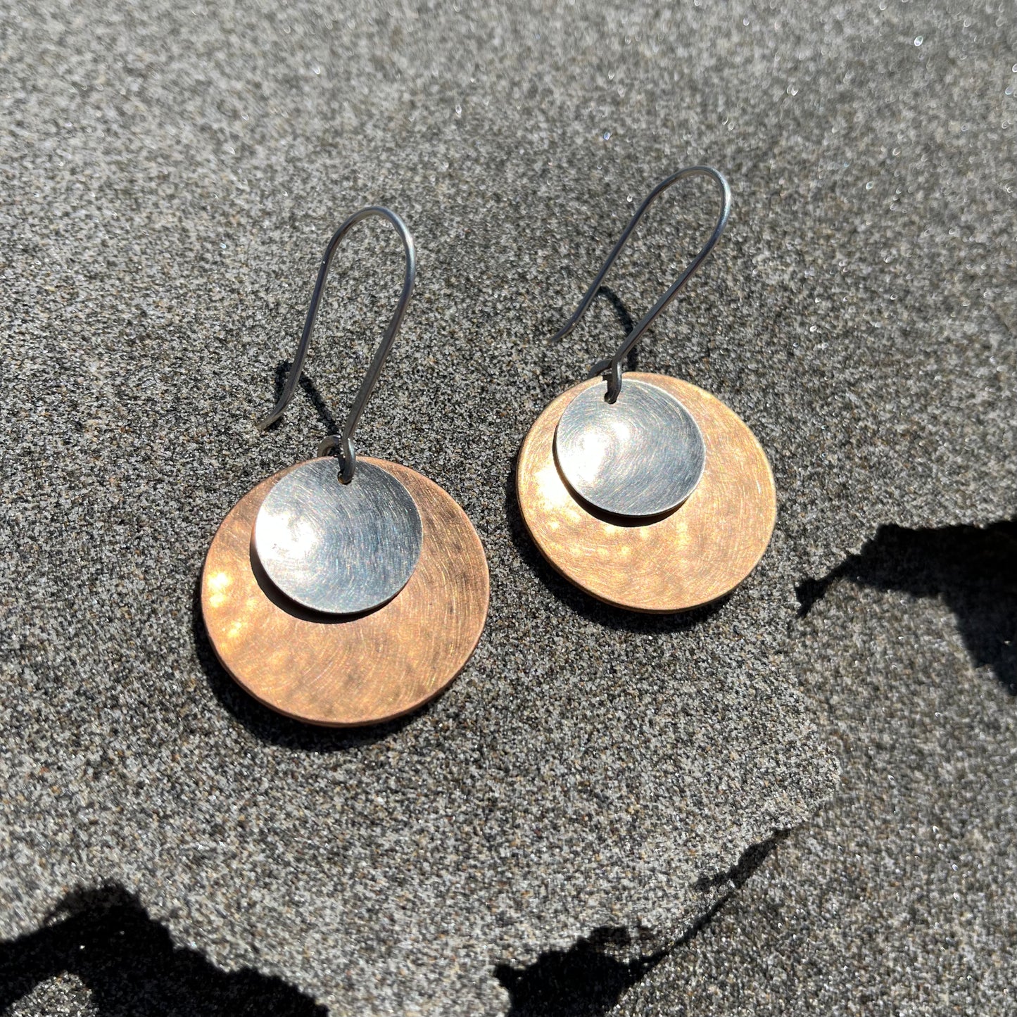 Hand hammered bronze and silver dangle earrings