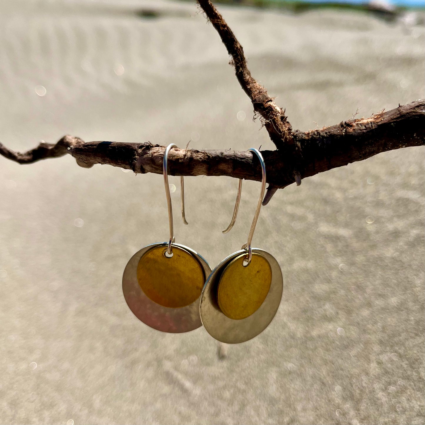 Hand hammered silver and brass dangle earrings