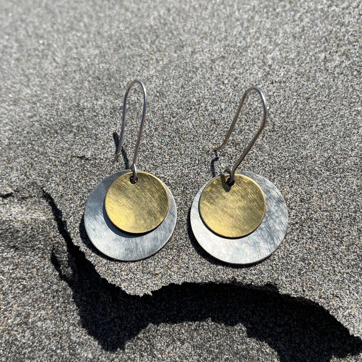 Hand hammered silver and brass dangle earrings