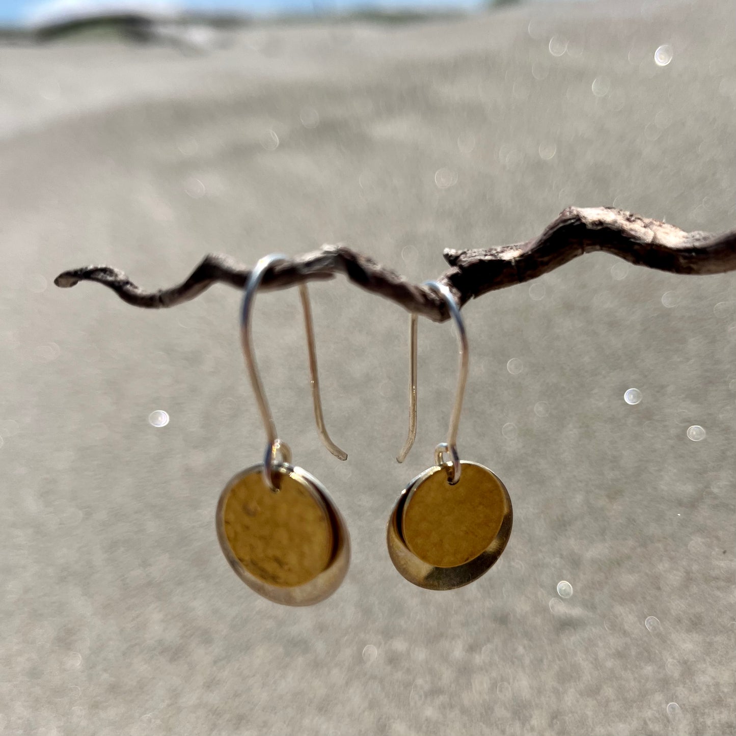 Hand hammered silver and brass dangle earrings