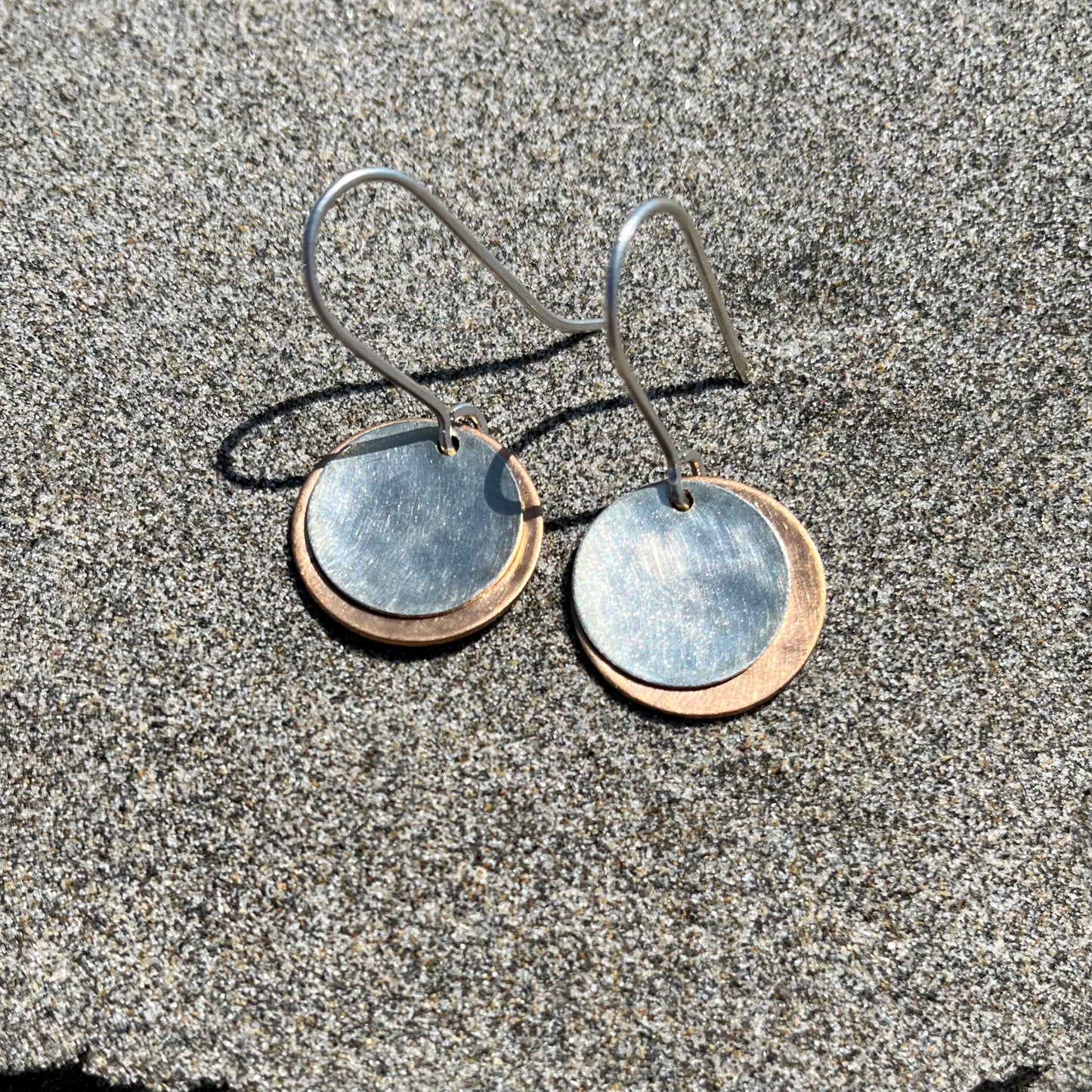 Hand hammered bronze and silver dangle earrings