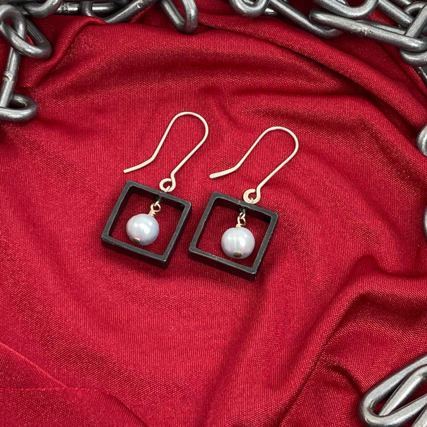 Blackened steel and pearl earrings with gold