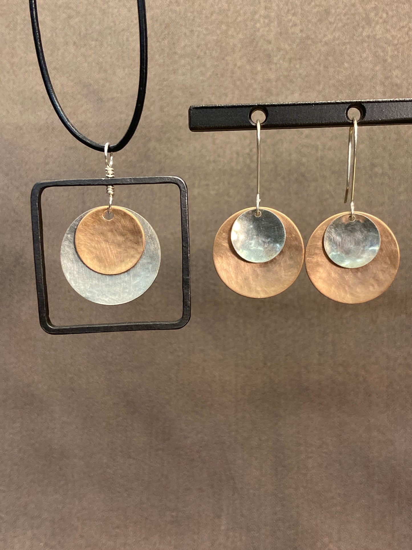 Bronze, silver and blackened steel pendant