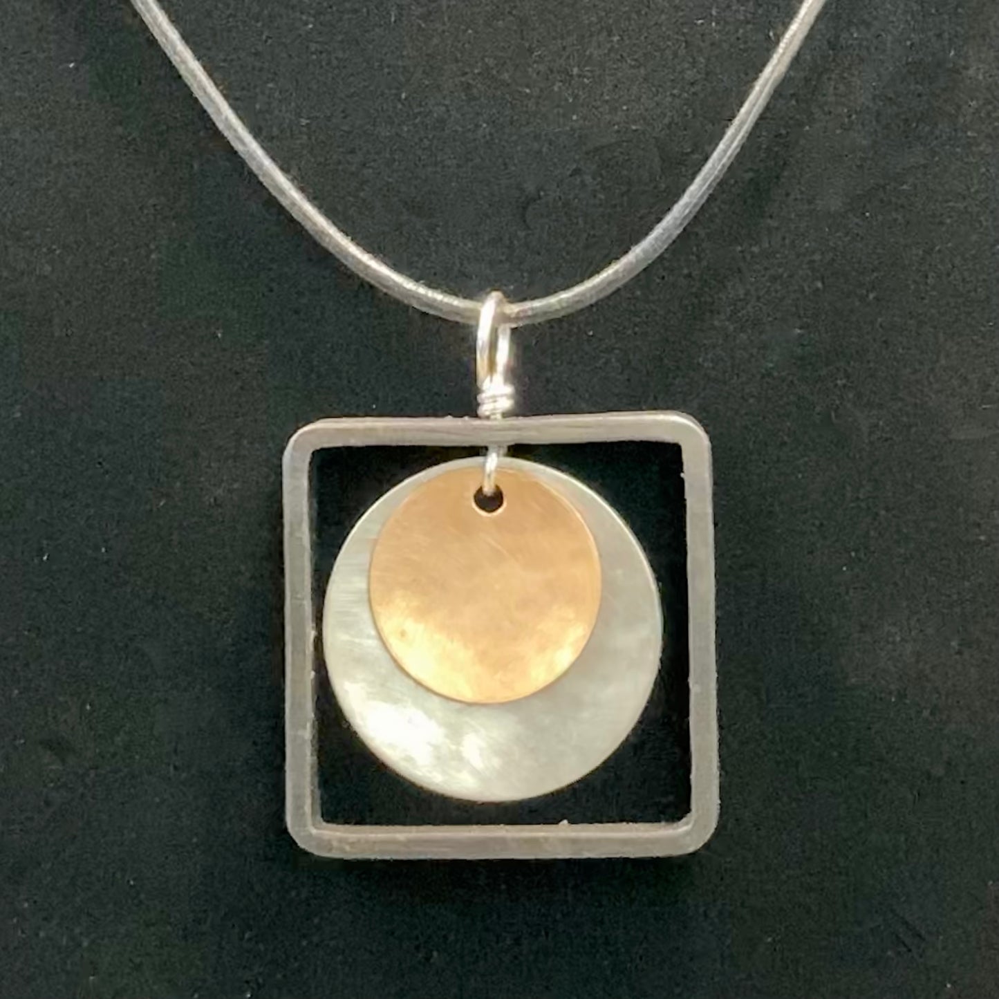 Blackened steel square pendant with silver and brass