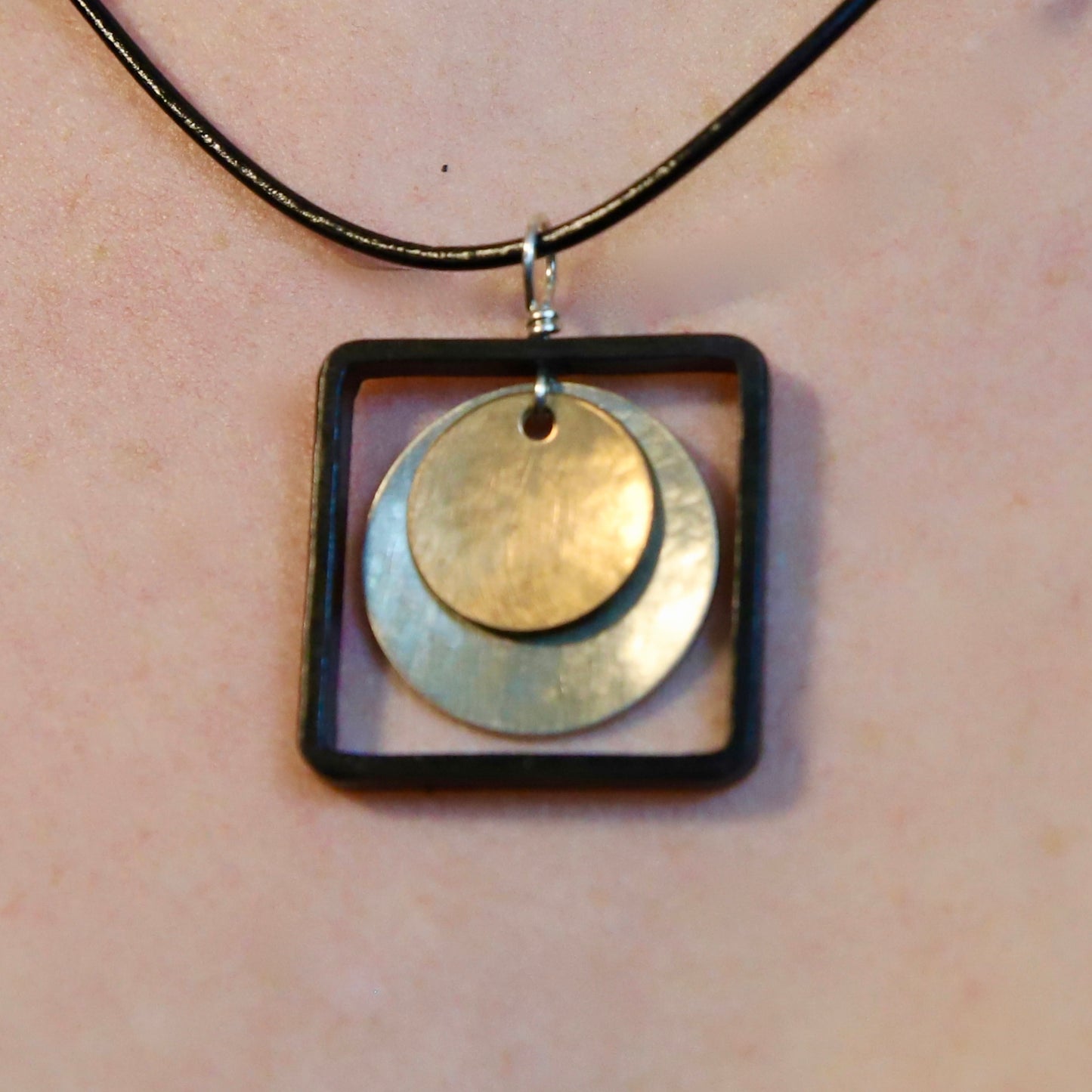 Blackened steel square pendant with silver and brass