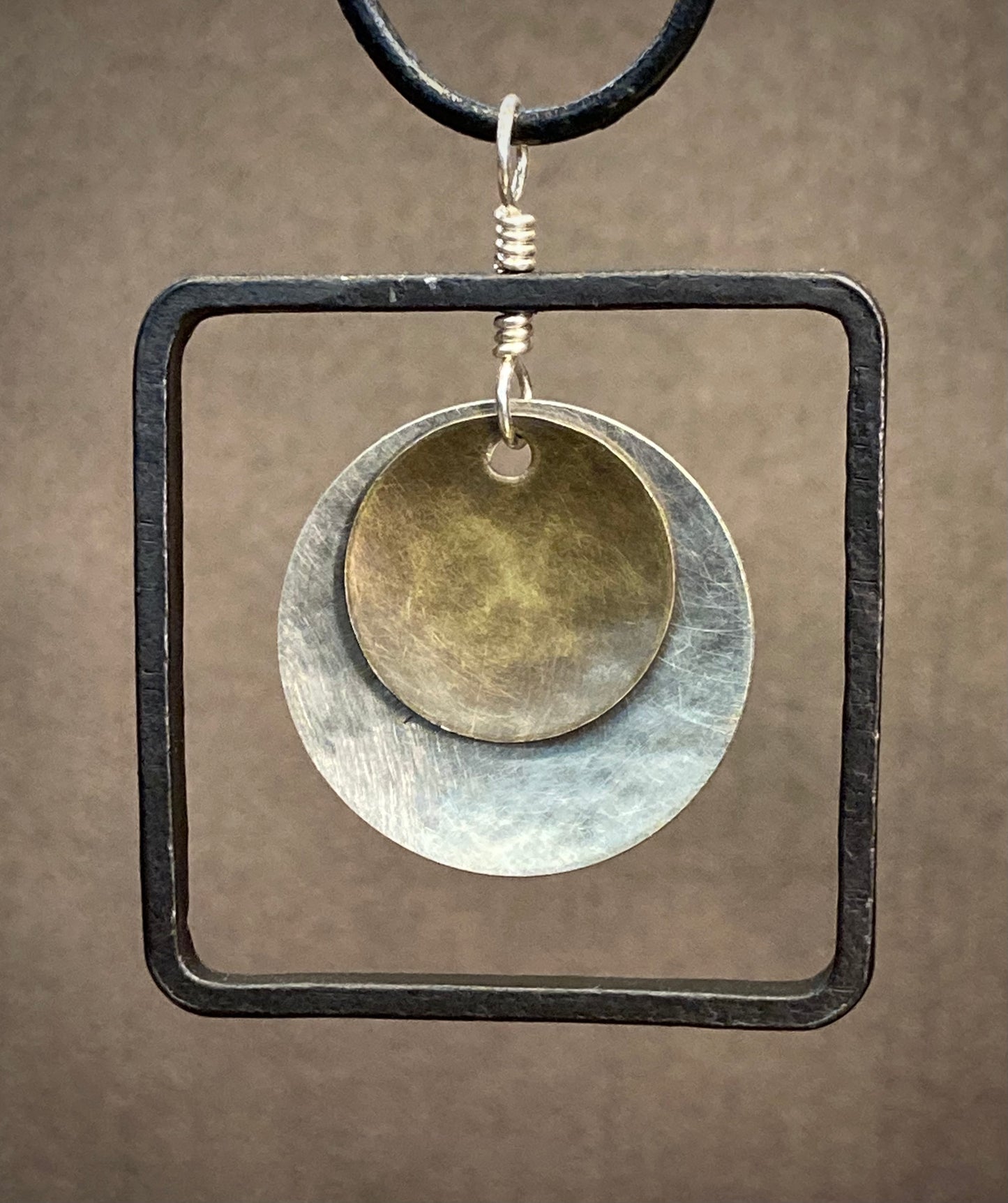 Blackened steel square pendant with silver and brass